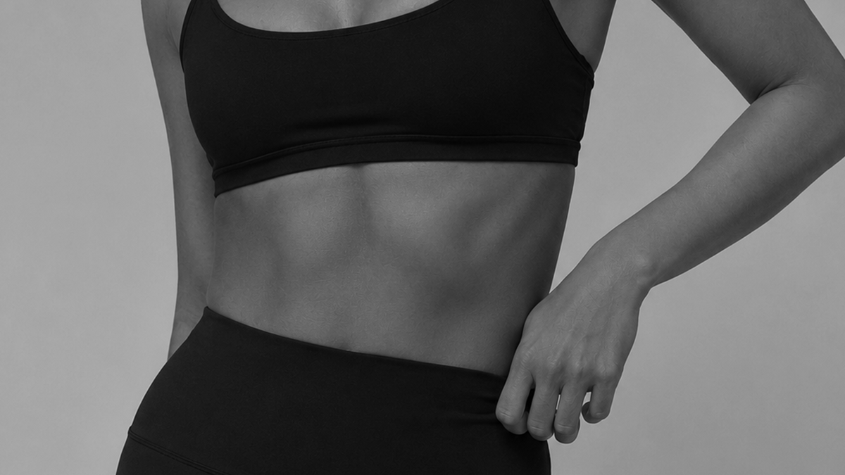 A rider photographed at the waist, torso in black and white