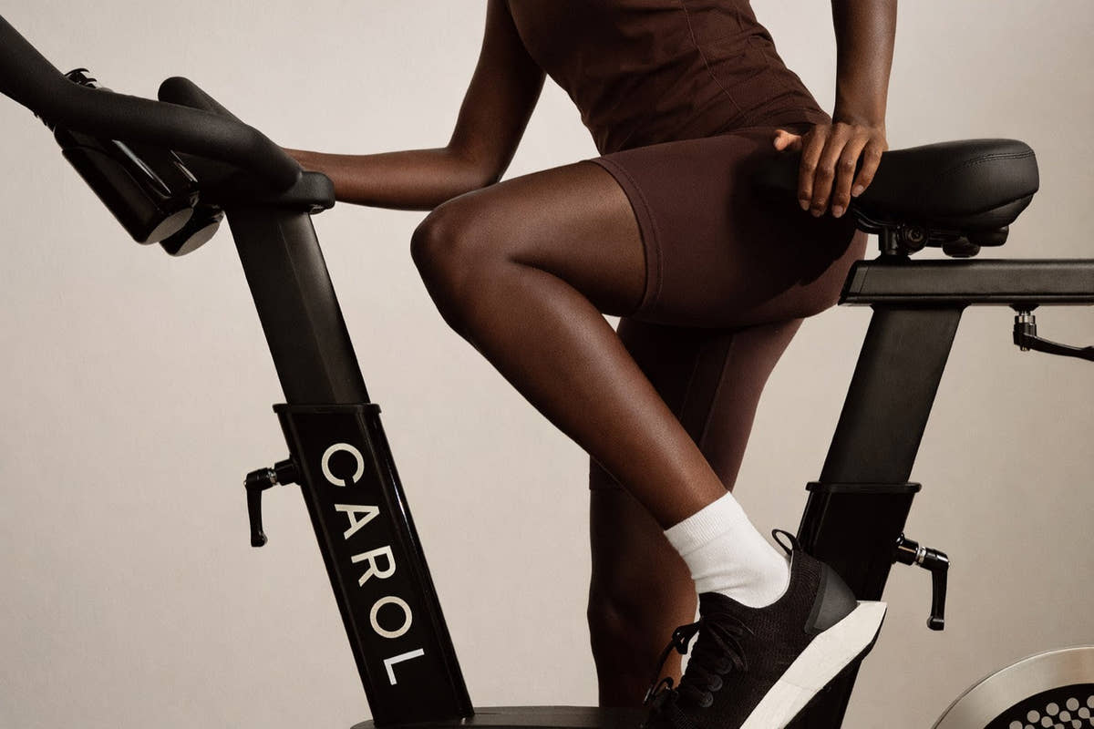 Close view of a rider's legs turning the pedals, CAROL Bike frame in profile